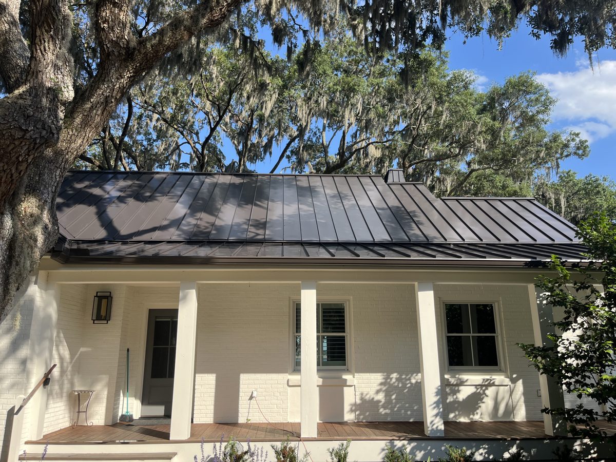 Bronze standing-seam porch roof, washed clean