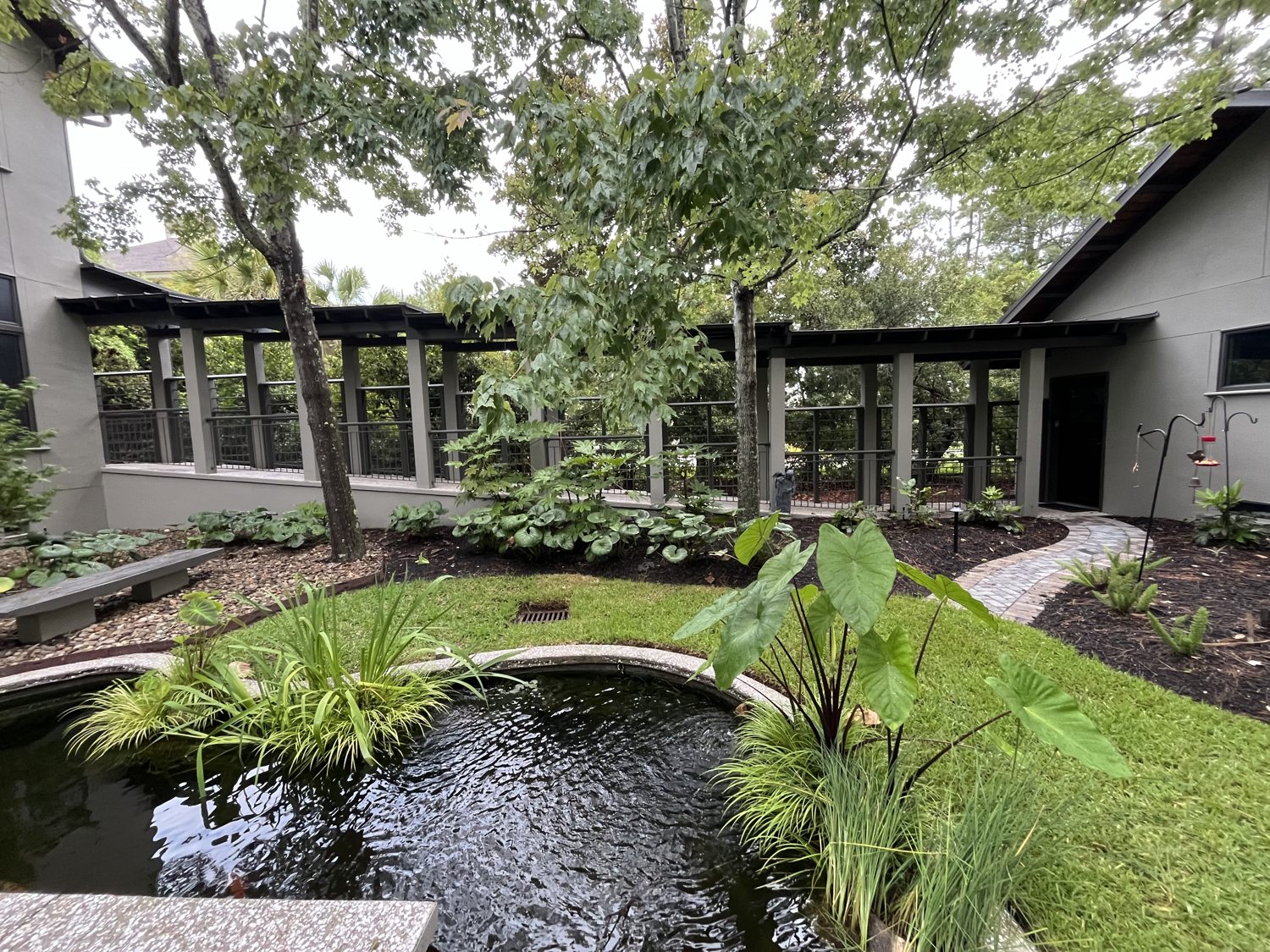 Immaculate courtyard, pond and walkways at a Lowcountry property maintained by SMRW